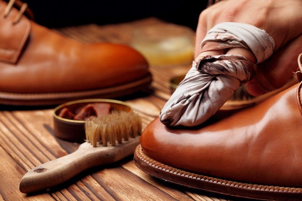 Shoes master polishing shoes with wax and cloth