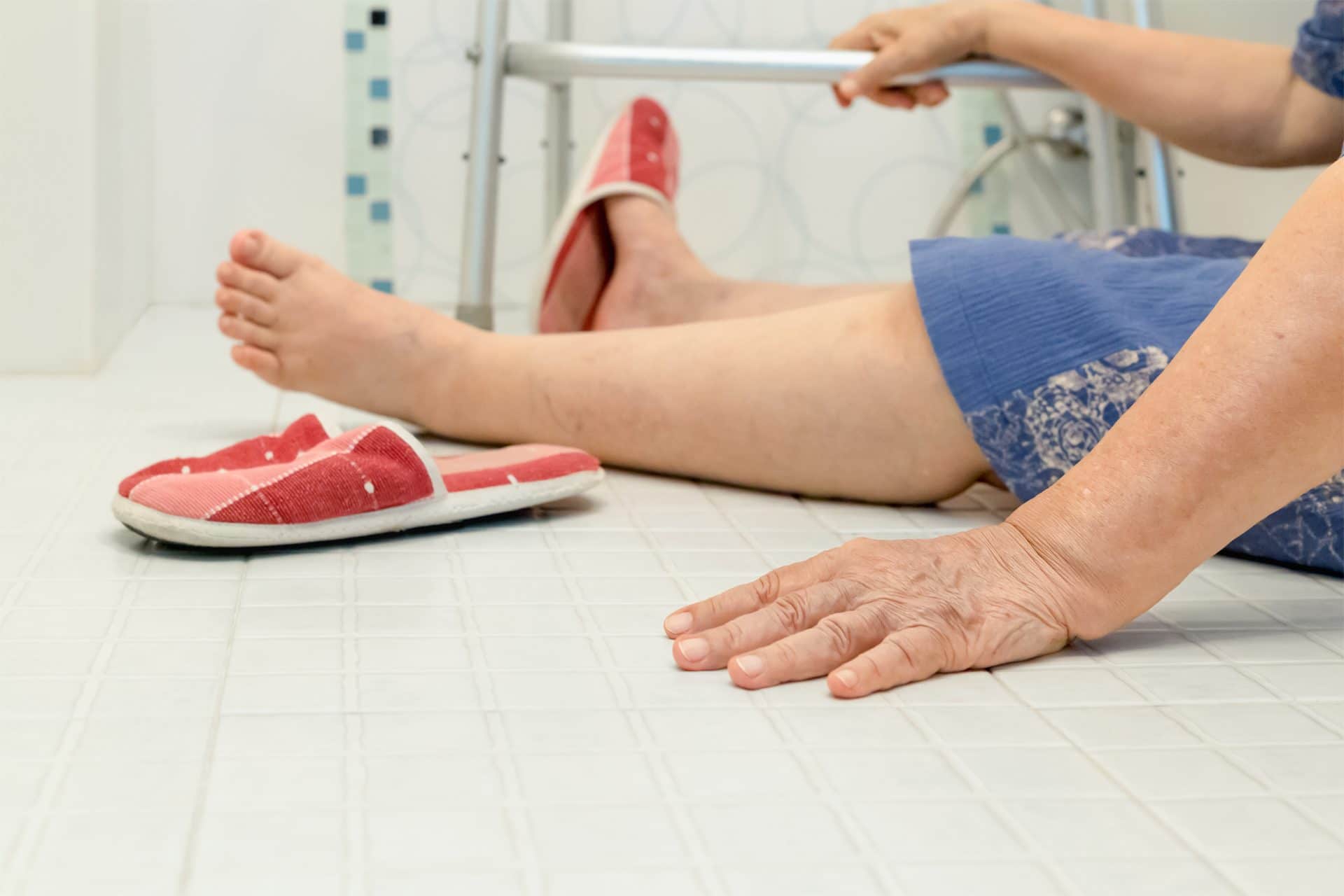close shot of slippery bathroom floor and legs of a woman after she slip and fell on the bathroom floor