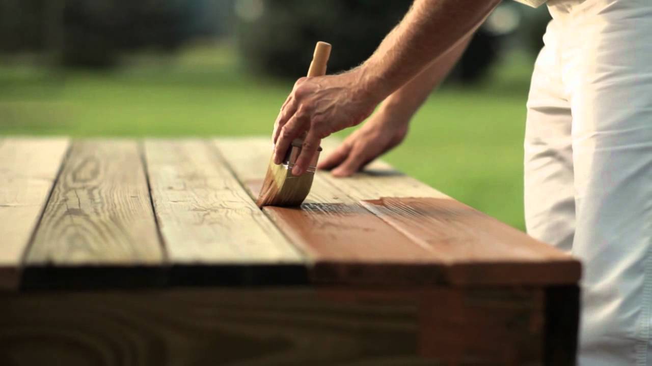 close shot of a hand polishing a wood table